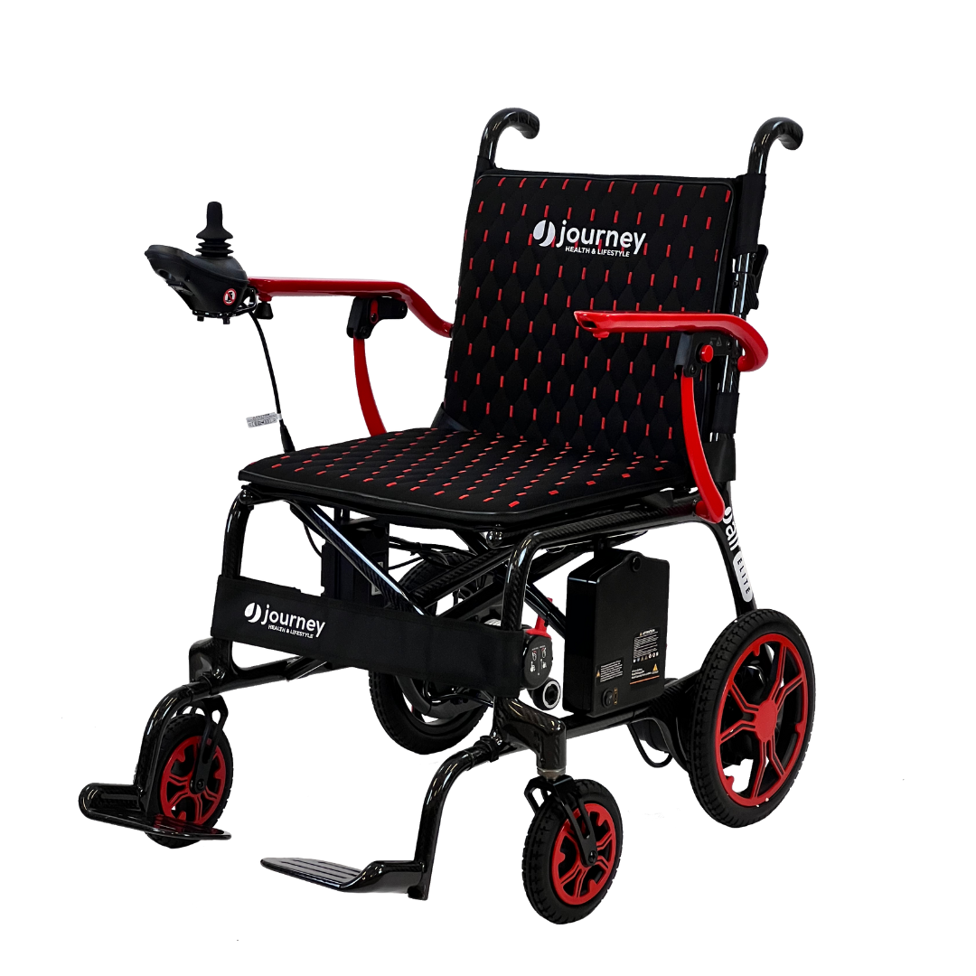 The Journey Air Elite Folding Carbon Fiber Powerchair - Only 29 lbs features a textured seat and backrest, right-arm joystick control, red wheel rims, and a foldable footrest. This lightweight design ensures comfort and is perfect for travel.